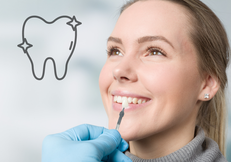 A dentist holds a sample dental implant to a patients mouth to match color