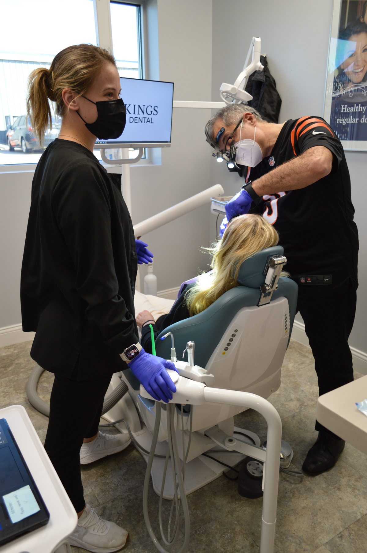 Dentist and Dental Assistant working with patient